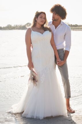 Plus size bride with groom on the beach. Mermaid plus size wedding dress in Orlando