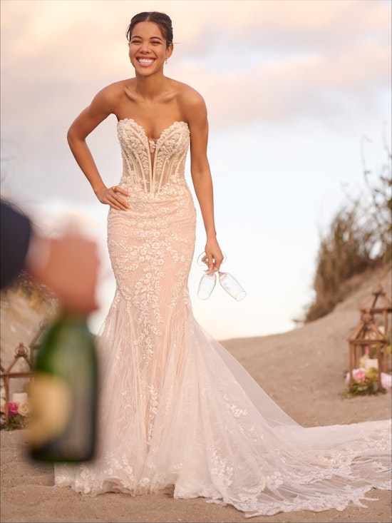bride on beach wearing lace wedding dress