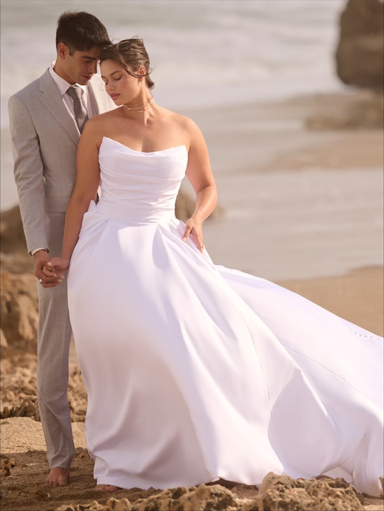 bride and groom on beach bride wearing ballgown with scoop neckline
