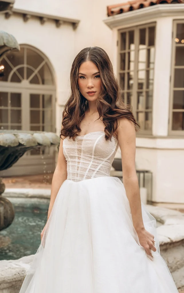 bride wearing strapless wedding dress with beaded bodice By Stella York